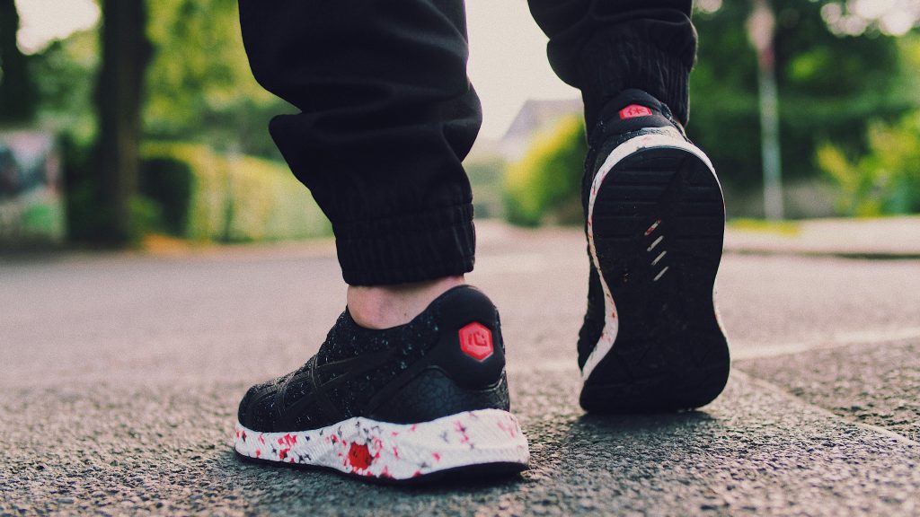 pexels photo 1153838 1153838 Close-up of a person walking with stylish sneakers on a bright street.